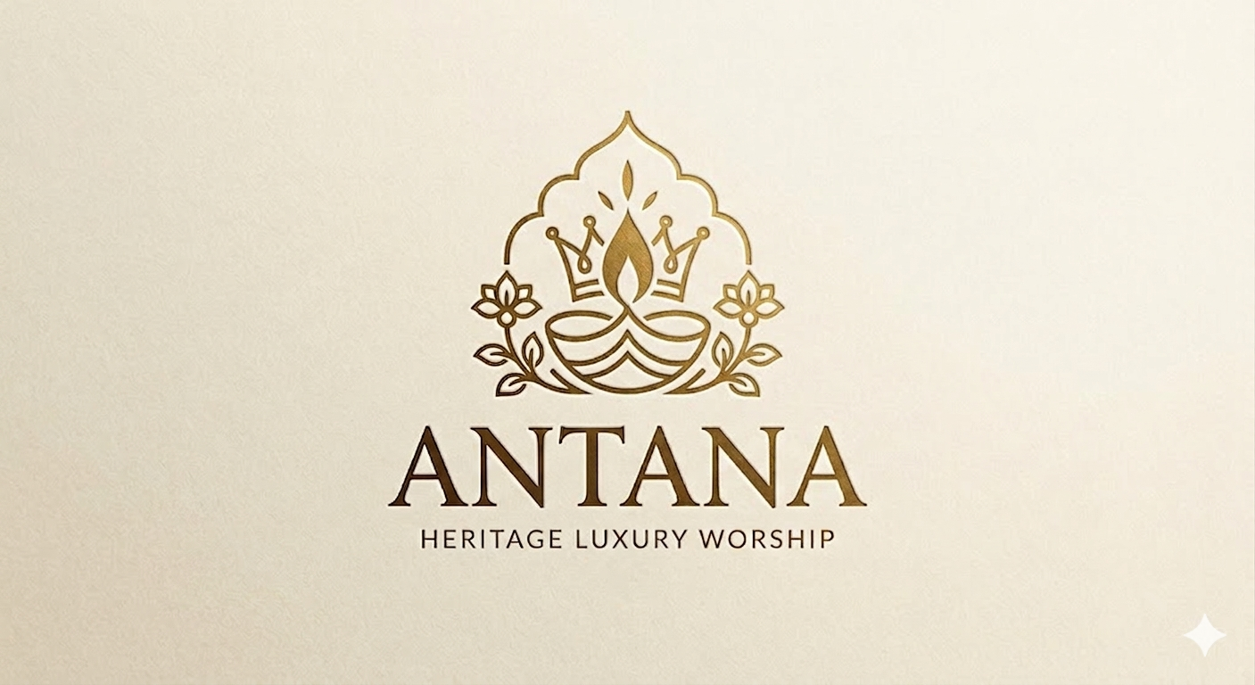 A lit diya visible through a royal arch, decorated with lotus flowers with a crown behind it. There is text under it that says, Heritage Luxury Workshop